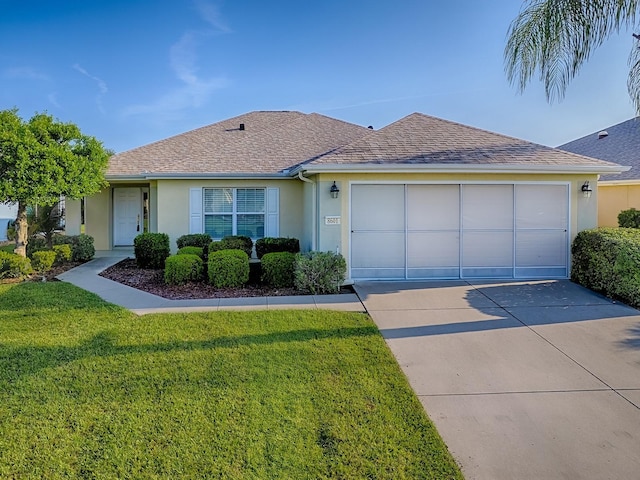 8601 SE 133rd St, Summerfield, FL 34491 - ranch-style house featuring stucco siding, concrete driveway, a garage, a front lawn, and roof with shingles