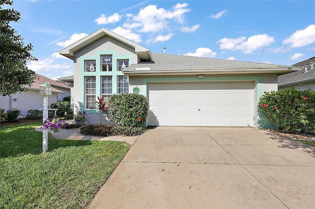 5604 Gulf Stream St, Tavares, FL 32778 - view of front of home featuring stucco siding, driveway, a garage, and a front yard