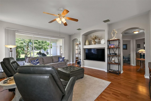 5604 Gulf Stream St, Tavares, FL 32778 - living room with arched walkways, a ceiling fan, wood finished floors, and baseboards