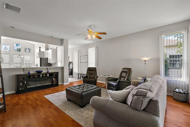 5604 Gulf Stream St, Tavares, FL 32778 - living area with a ceiling fan, wood finished floors, baseboards, and a textured ceiling