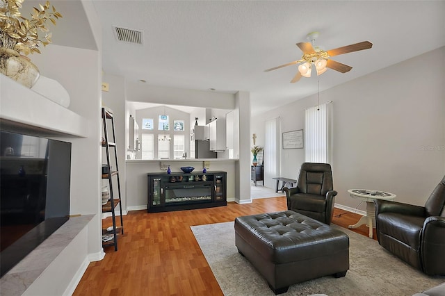 5604 Gulf Stream St, Tavares, FL 32778 - living area featuring a ceiling fan, wood finished floors, and baseboards