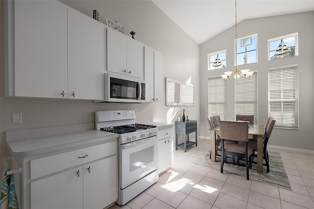 5604 Gulf Stream St, Tavares, FL 32778 - kitchen featuring white range with gas stovetop, a chandelier, lofted ceiling, light countertops, and light tile patterned flooring