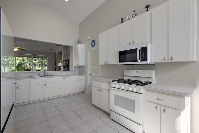 5604 Gulf Stream St, Tavares, FL 32778 - kitchen with white appliances, light tile patterned flooring, light countertops, a sink, and ceiling fan