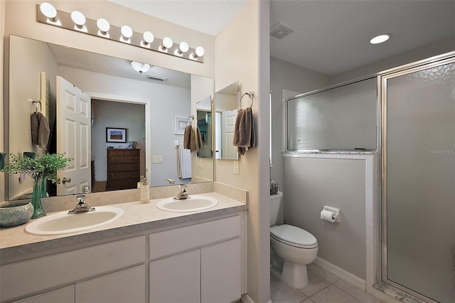 5604 Gulf Stream St, Tavares, FL 32778 - full bathroom with tile patterned floors, a stall shower, double vanity, and toilet