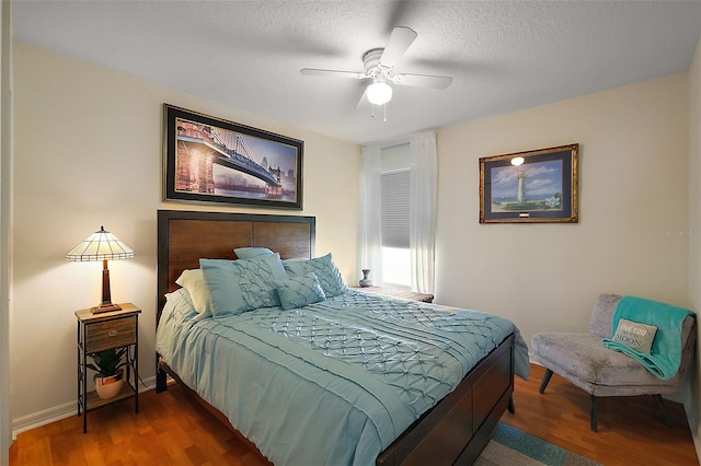 5604 Gulf Stream St, Tavares, FL 32778 - bedroom with wood finished floors, baseboards, ceiling fan, and a textured ceiling