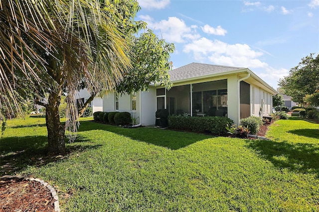 5604 Gulf Stream St, Tavares, FL 32778 - rear view of house featuring a yard, a sunroom, and stucco siding