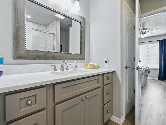 1722 Moreno Pl, The Villages, FL 32159 - full bath featuring vanity, a shower stall, wood finished floors, ceiling fan, and baseboards