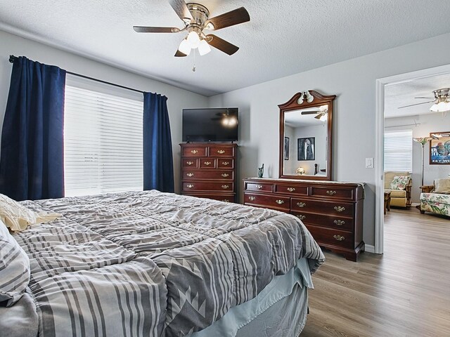 1722 Moreno Pl, The Villages, FL 32159 - bedroom featuring wood finished floors, a textured ceiling, ceiling fan, and baseboards