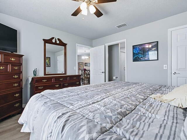 1722 Moreno Pl, The Villages, FL 32159 - bedroom featuring light wood-style flooring, ceiling fan, and a textured ceiling