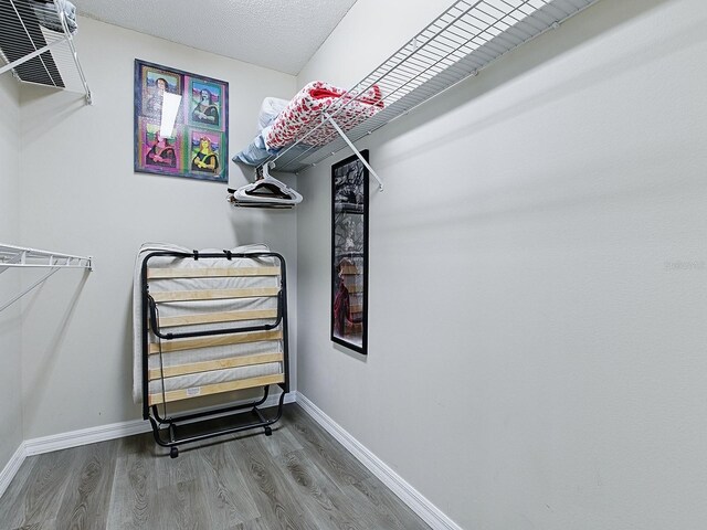 1722 Moreno Pl, The Villages, FL 32159 - walk in closet featuring wood finished floors