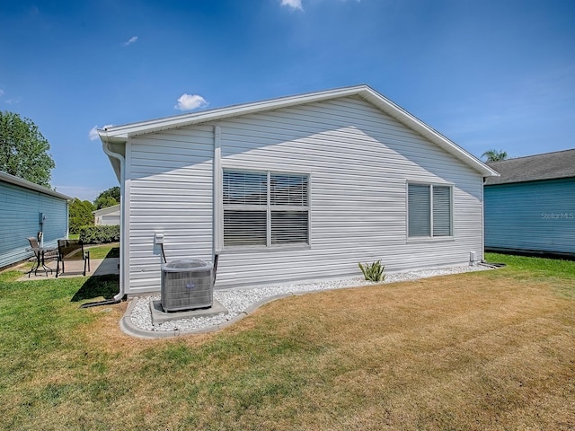 1722 Moreno Pl, The Villages, FL 32159 - view of property exterior with central AC unit and a lawn