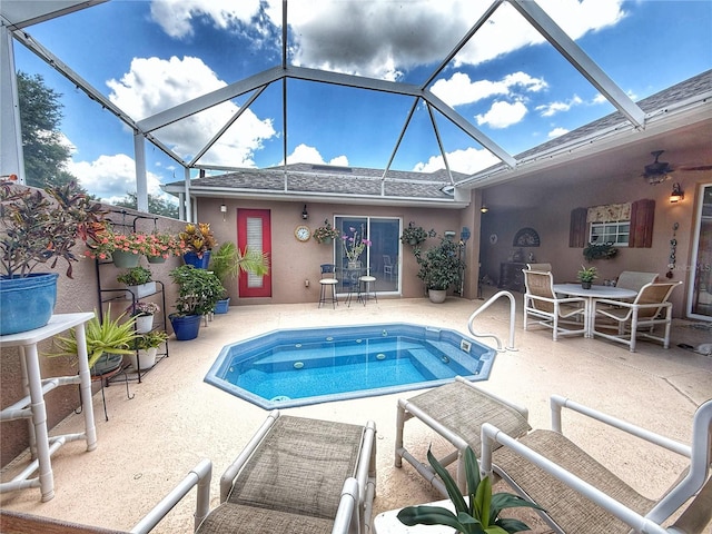 outdoor pool featuring a patio area, a ceiling fan, and glass enclosure