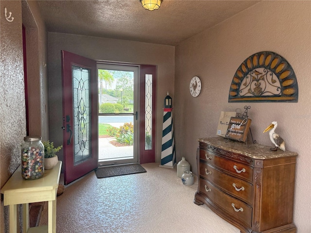 entryway with light carpet and a textured wall