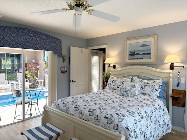 bedroom featuring access to exterior, wood finished floors, multiple windows, and a ceiling fan