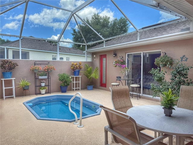 view of pool featuring a patio, a lanai, fence, and a hot tub