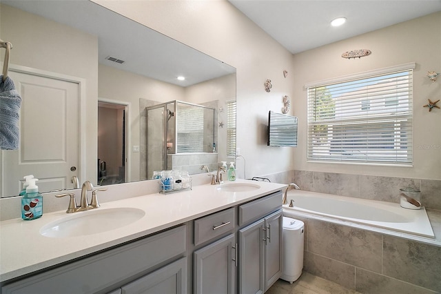 1155 Dora Parc Ln, Mount Dora, FL 32757 - bathroom featuring a bath, double vanity, a shower stall, and recessed lighting