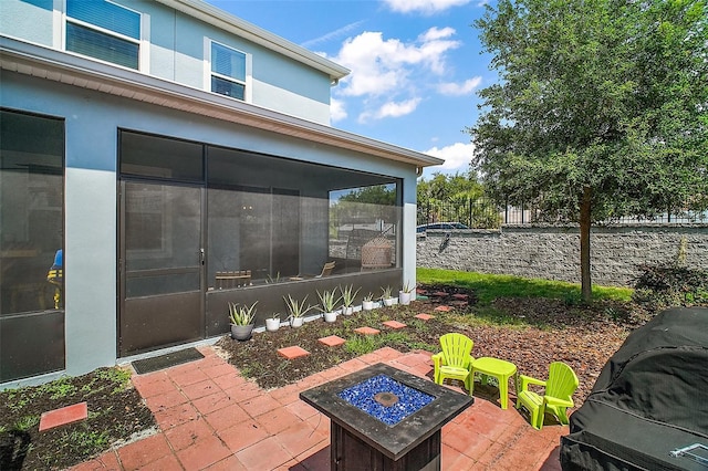 1155 Dora Parc Ln, Mount Dora, FL 32757 - view of patio featuring a sunroom and a fire pit