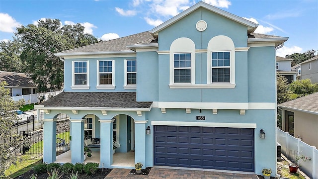 1155 Dora Parc Ln, Mount Dora, FL 32757 - view of front of house with stucco siding, an attached garage, a porch, and a shingled roof