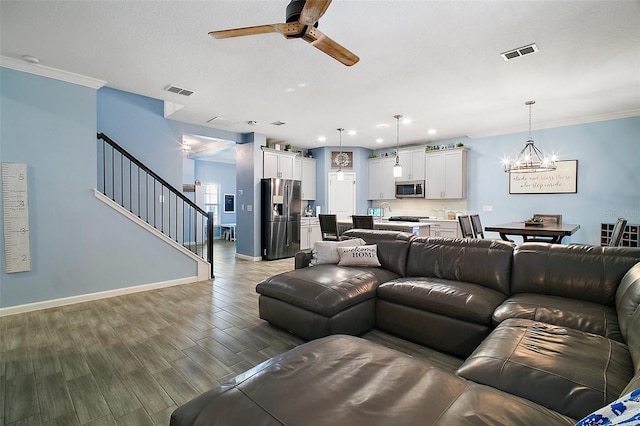 1155 Dora Parc Ln, Mount Dora, FL 32757 - living area featuring ceiling fan, stairs, wood finished floors, baseboards, and a chandelier