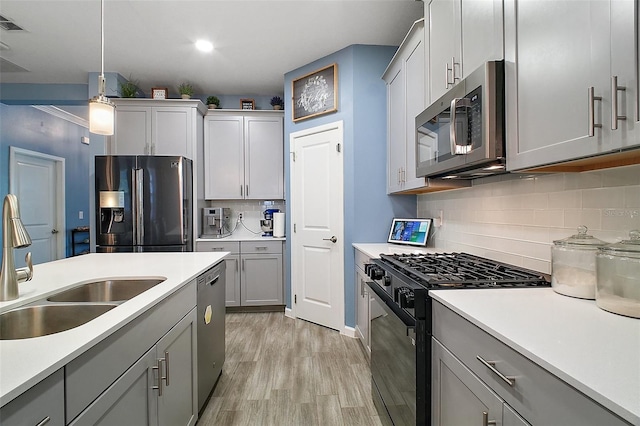 1155 Dora Parc Ln, Mount Dora, FL 32757 - kitchen with stainless steel appliances, a sink, gray cabinetry, and recessed lighting