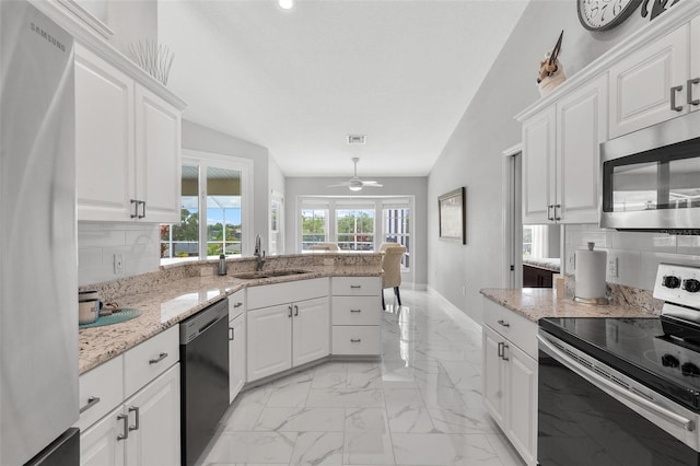 5400 Saddleback Ct, Lady Lake, FL 32159 - kitchen featuring stainless steel appliances, a sink, light marble finish flooring, and backsplash