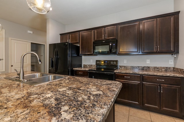 3194 Bayou Ln, Tavares, FL 32778 - kitchen featuring black appliances, a sink, light tile patterned floors, and dark brown cabinetry