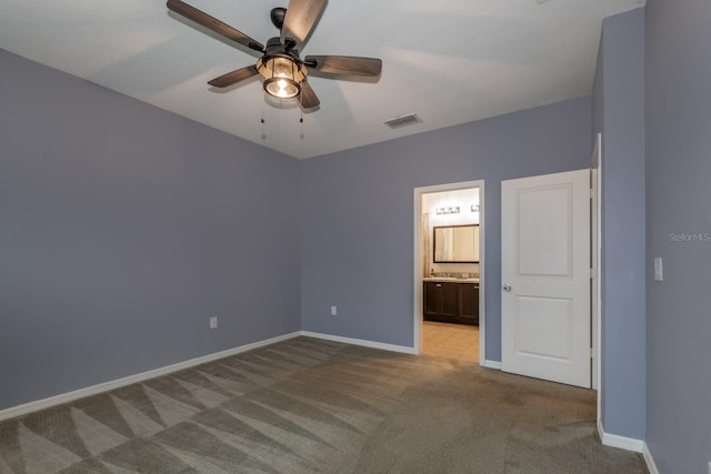 3194 Bayou Ln, Tavares, FL 32778 - unfurnished bedroom featuring carpet, baseboards, ensuite bathroom, and ceiling fan