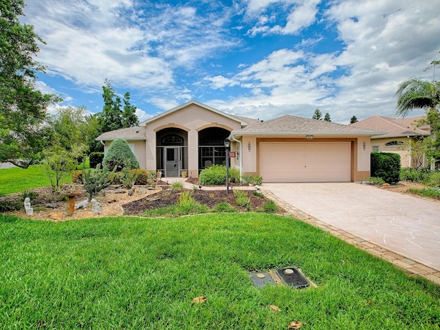 single story home featuring stucco siding, an attached garage, a front lawn, and concrete driveway