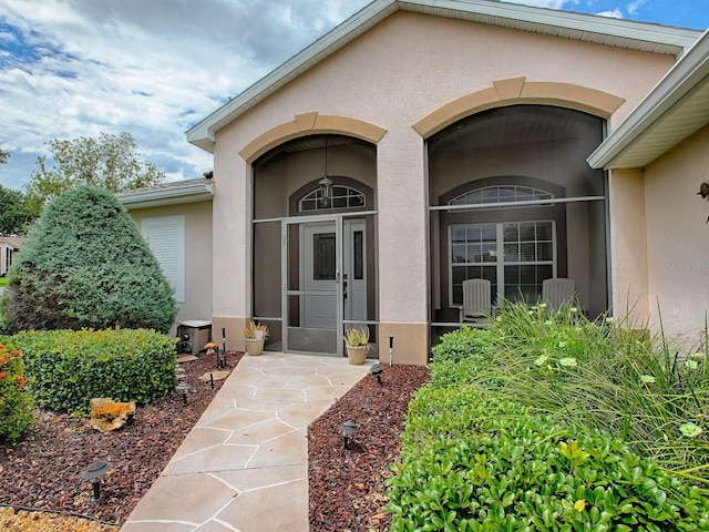 property entrance with stucco siding