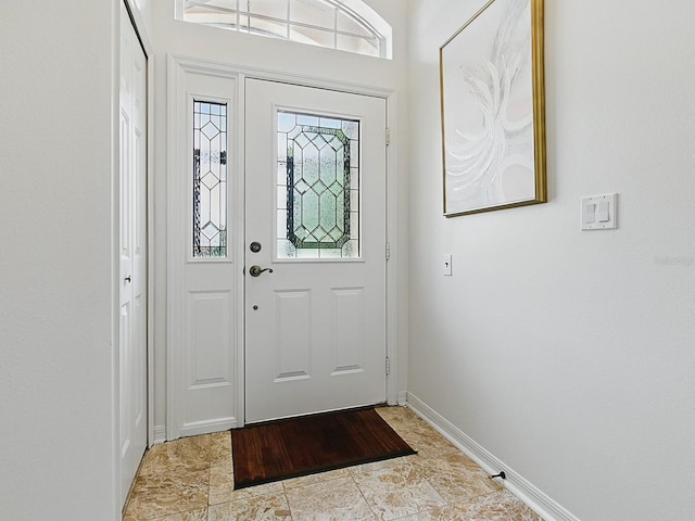 foyer featuring baseboards