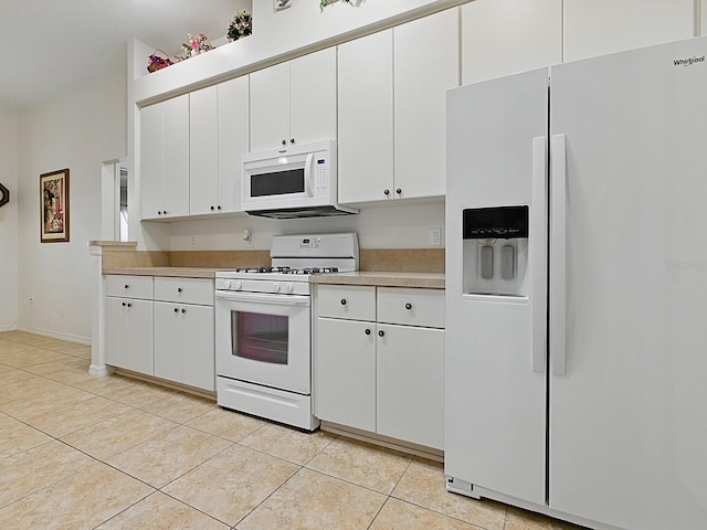 kitchen featuring white appliances, light countertops, light tile patterned floors, and white cabinetry