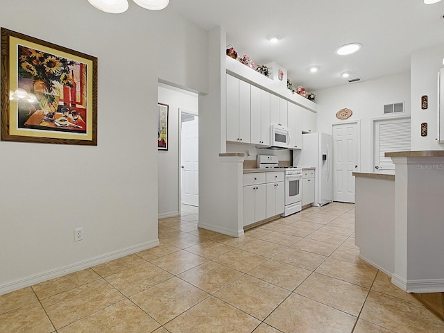kitchen featuring white appliances, light tile patterned floors, white cabinets, baseboards, and light countertops