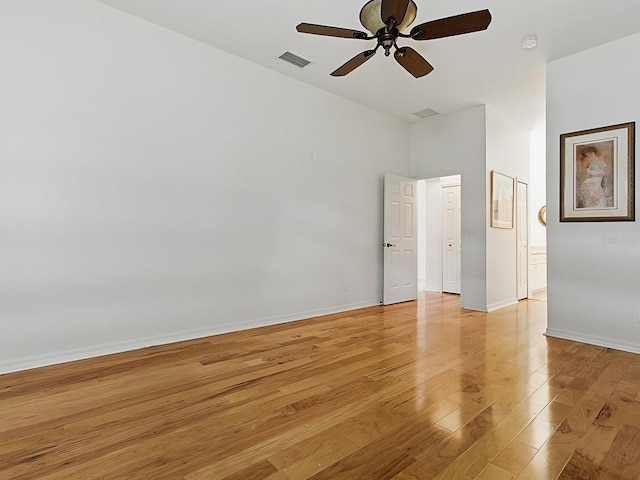 empty room with light wood-style flooring, ceiling fan, and baseboards