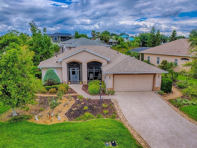 view of front of home featuring stucco siding, a garage, driveway, and a shingled roof