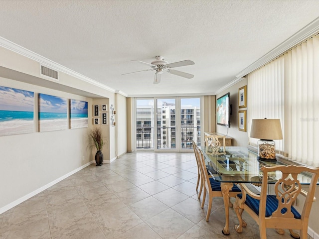 dining room featuring crown molding, ceiling fan, a textured ceiling, and baseboards
