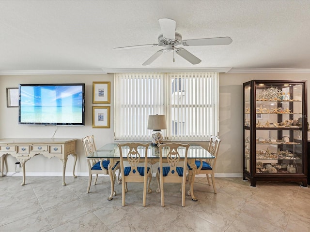 dining area featuring crown molding, a ceiling fan, plenty of natural light, baseboards, and a textured ceiling