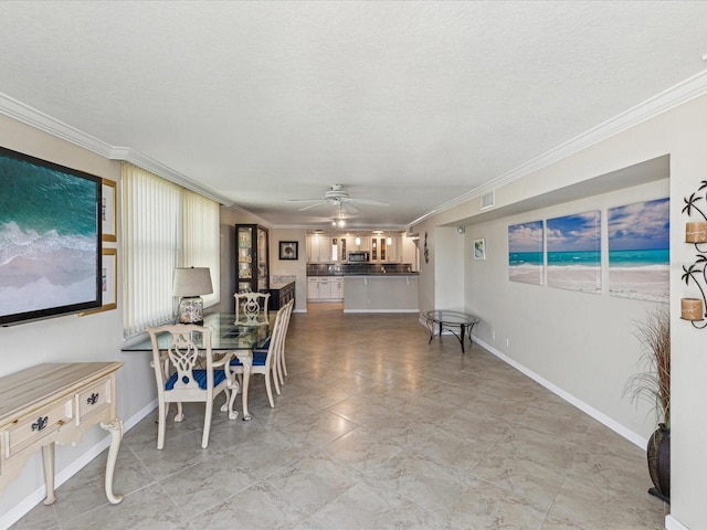 dining room with ornamental molding, a ceiling fan, baseboards, and a textured ceiling