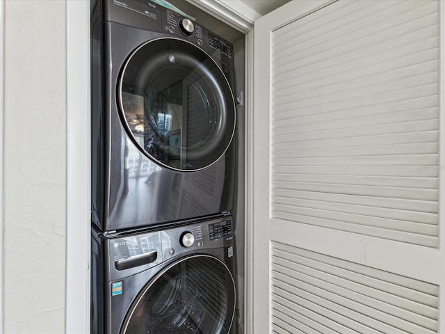 clothes washing area featuring estacked washer and dryer