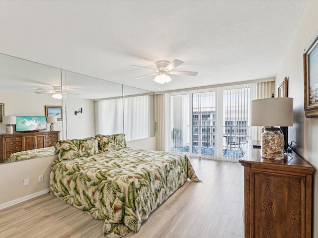 bedroom featuring access to outside, light wood-type flooring, and ceiling fan