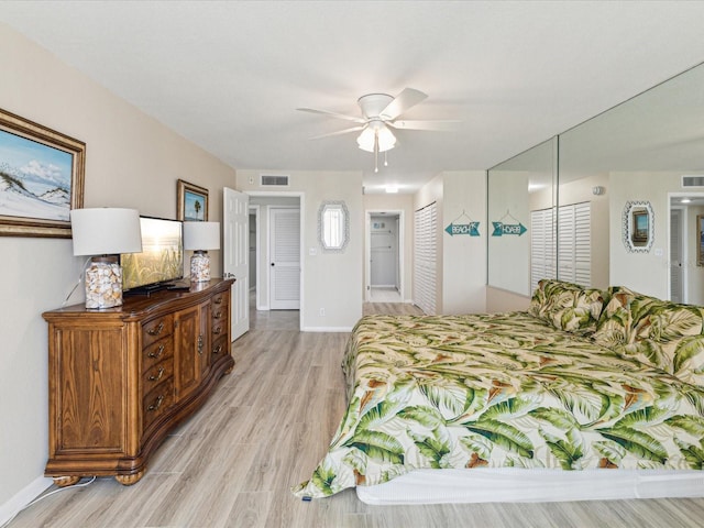 bedroom featuring light wood-style floors, a closet, baseboards, ceiling fan, and connected bathroom