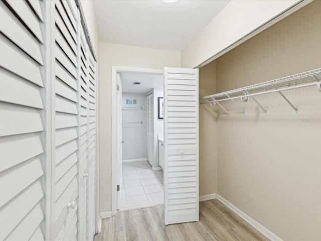 spacious closet featuring light wood finished floors
