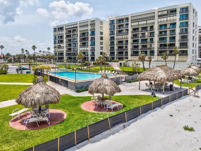 community pool with a gazebo and a lawn