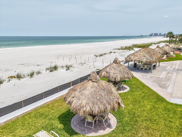 water view with a gazebo, local beach, and fence