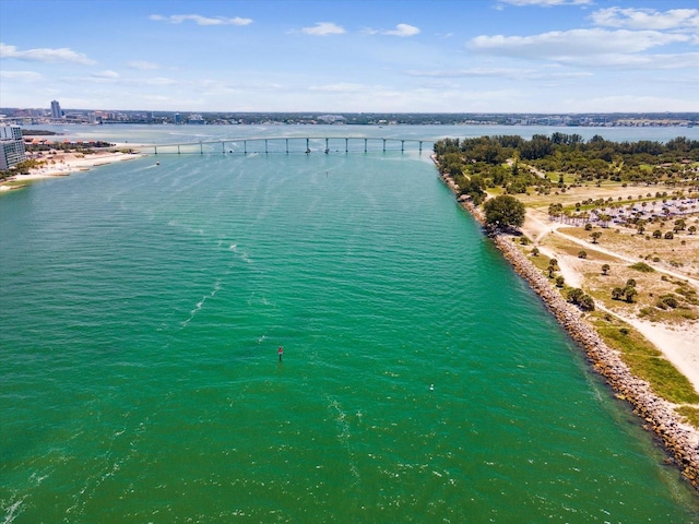 drone / aerial view of a nearby body of water and a notable bridge