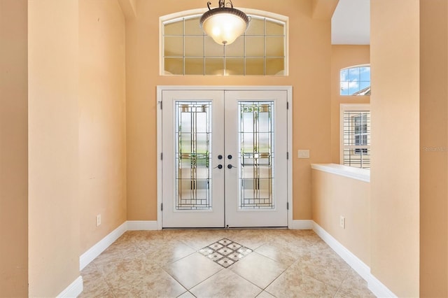 1123 Barnacle Ter, The Villages, FL 32162 - tiled entryway with french doors, a high ceiling, and baseboards