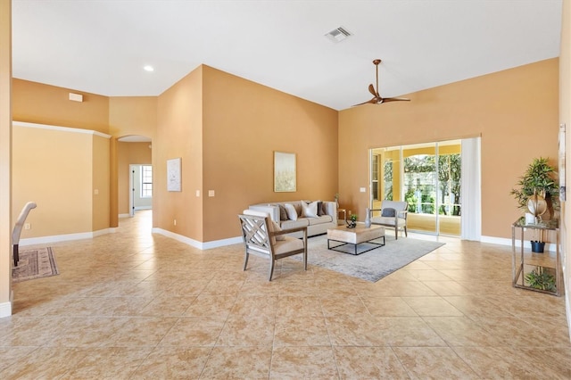 1123 Barnacle Ter, The Villages, FL 32162 - living area featuring a towering ceiling, arched walkways, healthy amount of natural light, baseboards, and ceiling fan