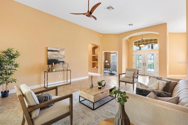 1123 Barnacle Ter, The Villages, FL 32162 - living room with french doors, arched walkways, ceiling fan, baseboards, and tile patterned floors