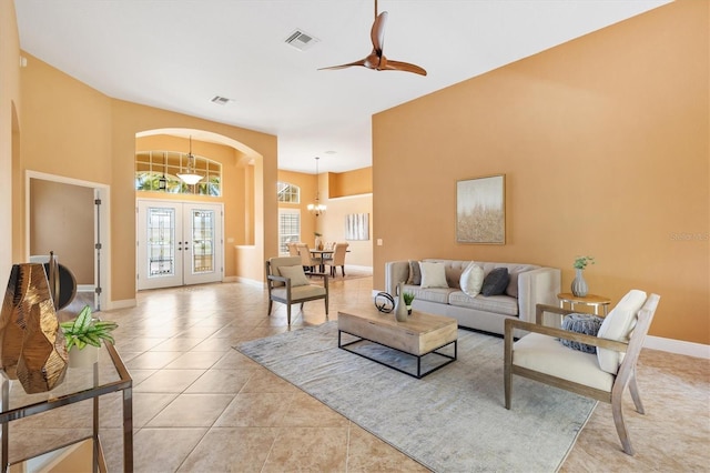 1123 Barnacle Ter, The Villages, FL 32162 - living room featuring french doors, arched walkways, a ceiling fan, light tile patterned floors, and baseboards