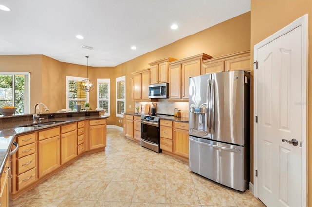 1123 Barnacle Ter, The Villages, FL 32162 - kitchen featuring stainless steel appliances, a sink, recessed lighting, light brown cabinetry, and light tile patterned floors