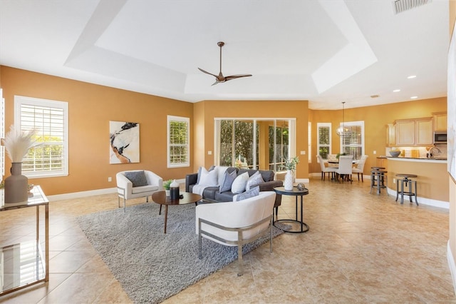 1123 Barnacle Ter, The Villages, FL 32162 - living room with a raised ceiling, light tile patterned flooring, baseboards, a ceiling fan, and recessed lighting